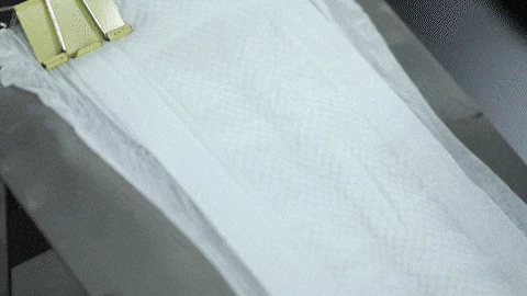 Binubuksan ang tela ng tela mula sa isang dispenser.