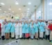 A group photo of employees at the pampers manufacturer