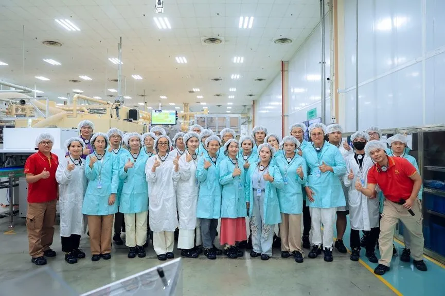 A group photo of employees at the pampers manufacturer